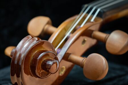 Close up of wooden violin on a dark backgroundの写真素材