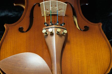 Close up of wooden violin on a dark backgroundの写真素材