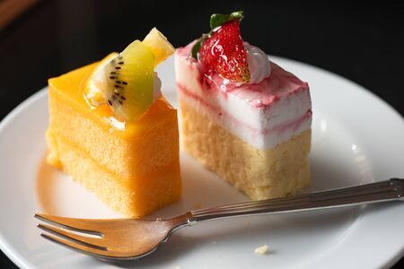 Fresh orange cake and Strawberry yoghurt cheese cake on a white plate, Close-upの写真素材