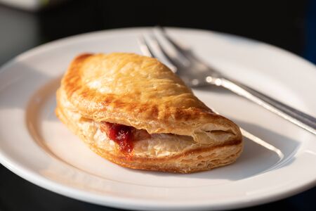 Barbecue pork pie on a white plate with black backgrounds