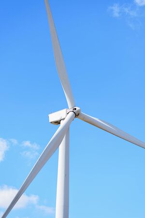 Close-up of wind turbines, wind power converters with blue sky backgroundの写真素材