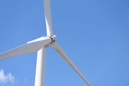 Close-up of wind turbines, wind power converters with blue sky backgroundの写真素材