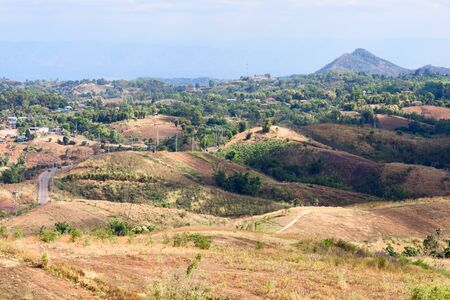 Urban landscape on a hill with mountains and blue backgrounds.の写真素材