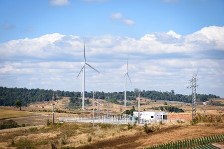 Wind turbine electrical power plant on a mountain, wind turbines farm, wind power plant with blue sky backgroundの写真素材
