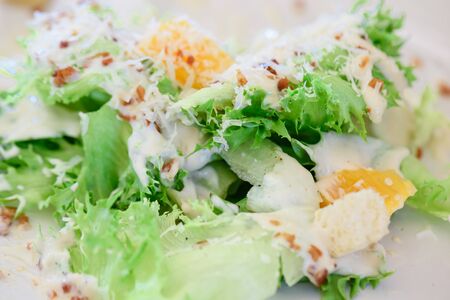 Close up caesar salad with crispy bacon and  caesar salad dressingの写真素材