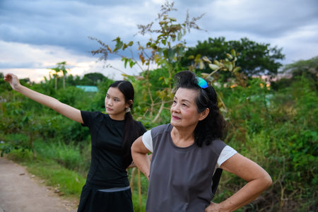 Grandmother and granddaughter enjoy a walk together in the park.の写真素材