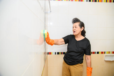 Mom is cleaning the bathroom, sink, and toiletの写真素材