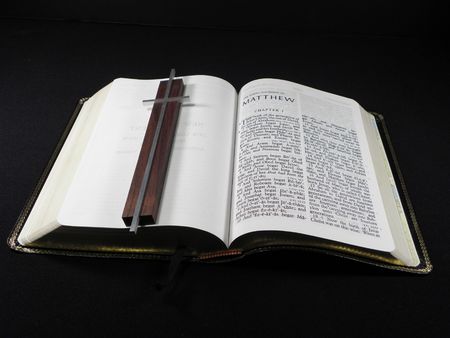 Open Bible with Silver and Wood Cross Overlaid