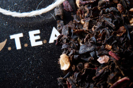 High quality photo about On the table are tea and tea leaves in dark colors top viewの写真素材