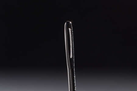 sewing needle on the table, macro photo with blurred background