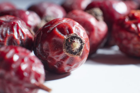 berries dry rosehip lie on the table a few pieces macro photo close up background blurredの写真素材