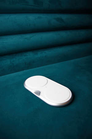 stylish wireless charger for smartphone on the table background is blurredの写真素材