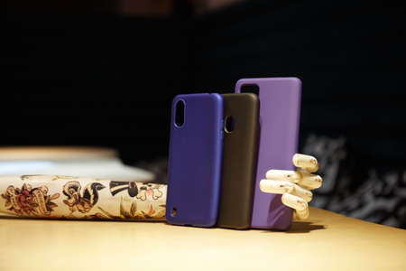 artificial mannequin arm holds modern Smartphone cases on the table background blurredの写真素材