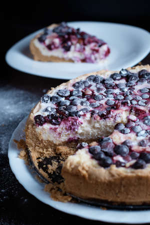Berry pie cake from the cherries currants in a bowl of fresh steam a whole and slices of hot background blurredの写真素材