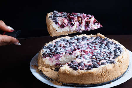 Berry pie cake from the cherries currants in a bowl of fresh, steaming hot cuts off a piece of the background is blurredの写真素材