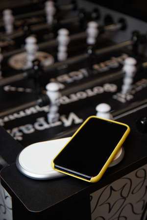 smartphone case on the table for the board game table football blurred backgroundの写真素材