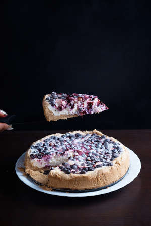 Berry pie cake from the cherries currants in a bowl of fresh, steaming hot cuts off a piece of the background is blurredの写真素材