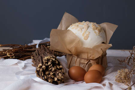 traditional Christian holiday, Easter cakes and eggs on the table dry plants, willow