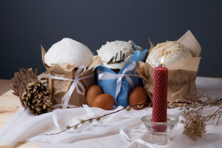 traditional Christian holiday, Easter cakes and eggs on the table dry plants, willow
