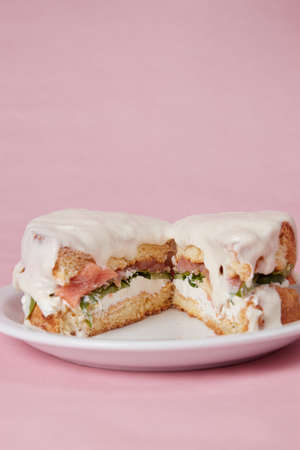 pancakes with fish, lettuce leaves and vegetables, a hot dish for lunch, pastries with sour creamの写真素材