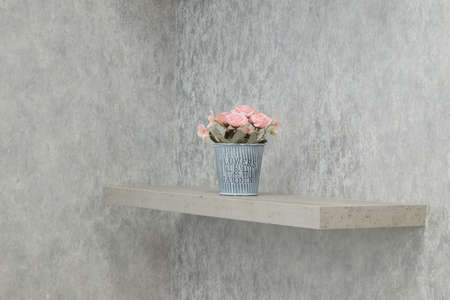 artificial flowers in a pot on a shelf, interior decoration, minimalistic decorの写真素材
