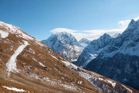 Dombay, alps, snow-covered slopes, the first snow in the mountains, sun and good weather, winter ski seasonの写真素材