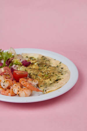 salad and omelet in a plate, tomatoes, cucumbers, greens and cabbage, diet food and drink for breakfast and lunchの写真素材