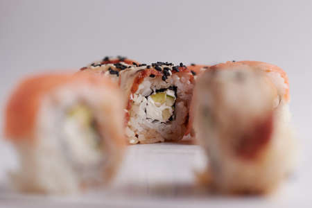 One roll in focus, a portion of rolls out of focus, Asian food, sushi and fish dishの写真素材