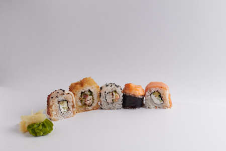 several different rolls on the table, Asian food, side view, light background, sushi, ginger and wasabiの写真素材