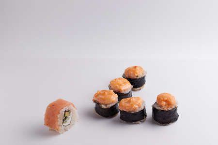 several different rolls on the table, Asian food, side view, light background, sushi, ginger and wasabiの写真素材