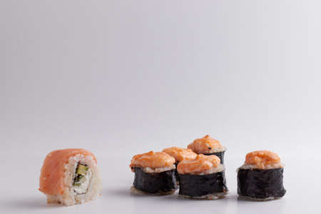 several different rolls on the table, Asian food, side view, light background, sushi, ginger and wasabiの写真素材