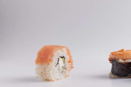 several different rolls on the table, Asian food, side view, light background, sushi, ginger and wasabiの写真素材