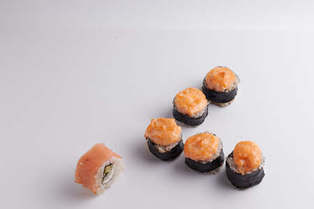 several different rolls on the table, Asian food, side view, light background, sushi, ginger and wasabiの写真素材