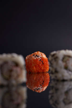 One roll in focus, a portion of rolls out of focus, Asian food, sushi and fish dishの写真素材