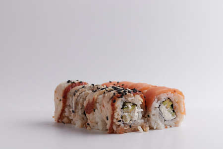 a portion of rolls on a stand, japanese food, sushi on the table, chinese chopsticks, light backgroundの写真素材