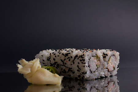 a portion of rolls on a stand, japanese food, sushi on the table, chinese chopsticks, light backgroundの写真素材