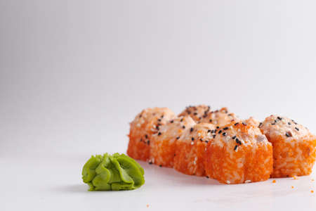 a portion of rolls on a stand, japanese food, sushi on the table, chinese chopsticks, light backgroundの写真素材