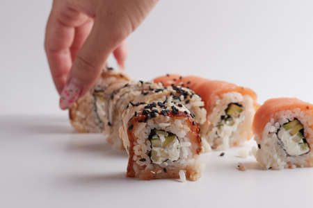 One roll in focus, a portion of rolls out of focus, Asian food, sushi and fish dishの写真素材