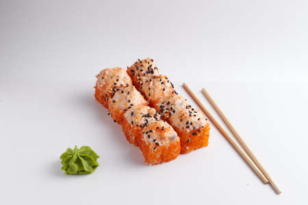 a portion of rolls on a stand, japanese food, sushi on the table, chinese chopsticks, light backgroundの写真素材