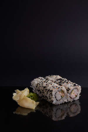 a portion of rolls on a stand, japanese food, sushi on the table, chinese chopsticks, light backgroundの写真素材