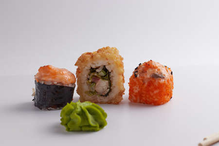 several different rolls on the table, Asian food, side view, light background, sushi, ginger and wasabiの写真素材