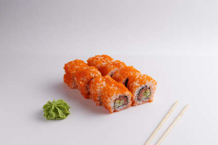 a portion of rolls on a stand, japanese food, sushi on the table, chinese chopsticks, light backgroundの写真素材