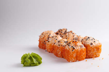a portion of rolls on a stand, japanese food, sushi on the table, chinese chopsticks, light backgroundの写真素材