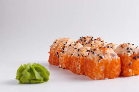 a portion of rolls on a stand, japanese food, sushi on the table, chinese chopsticks, light backgroundの写真素材