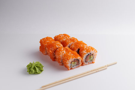 a portion of rolls on a stand, japanese food, sushi on the table, chinese chopsticks, light backgroundの写真素材