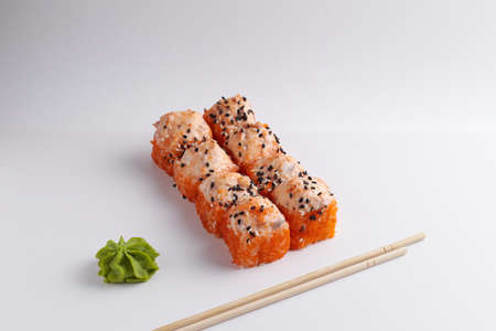 a portion of rolls on a stand, japanese food, sushi on the table, chinese chopsticks, light backgroundの写真素材