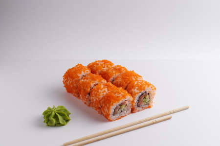 a portion of rolls on a stand, japanese food, sushi on the table, chinese chopsticks, light backgroundの写真素材