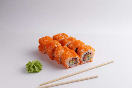 a portion of rolls on a stand, japanese food, sushi on the table, chinese chopsticks, light backgroundの写真素材