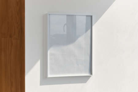 large photo frame on a white wall mockup, changeable design, psdの写真素材