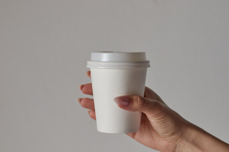 coffee cup in hand, mockup, custom design, close-upの写真素材